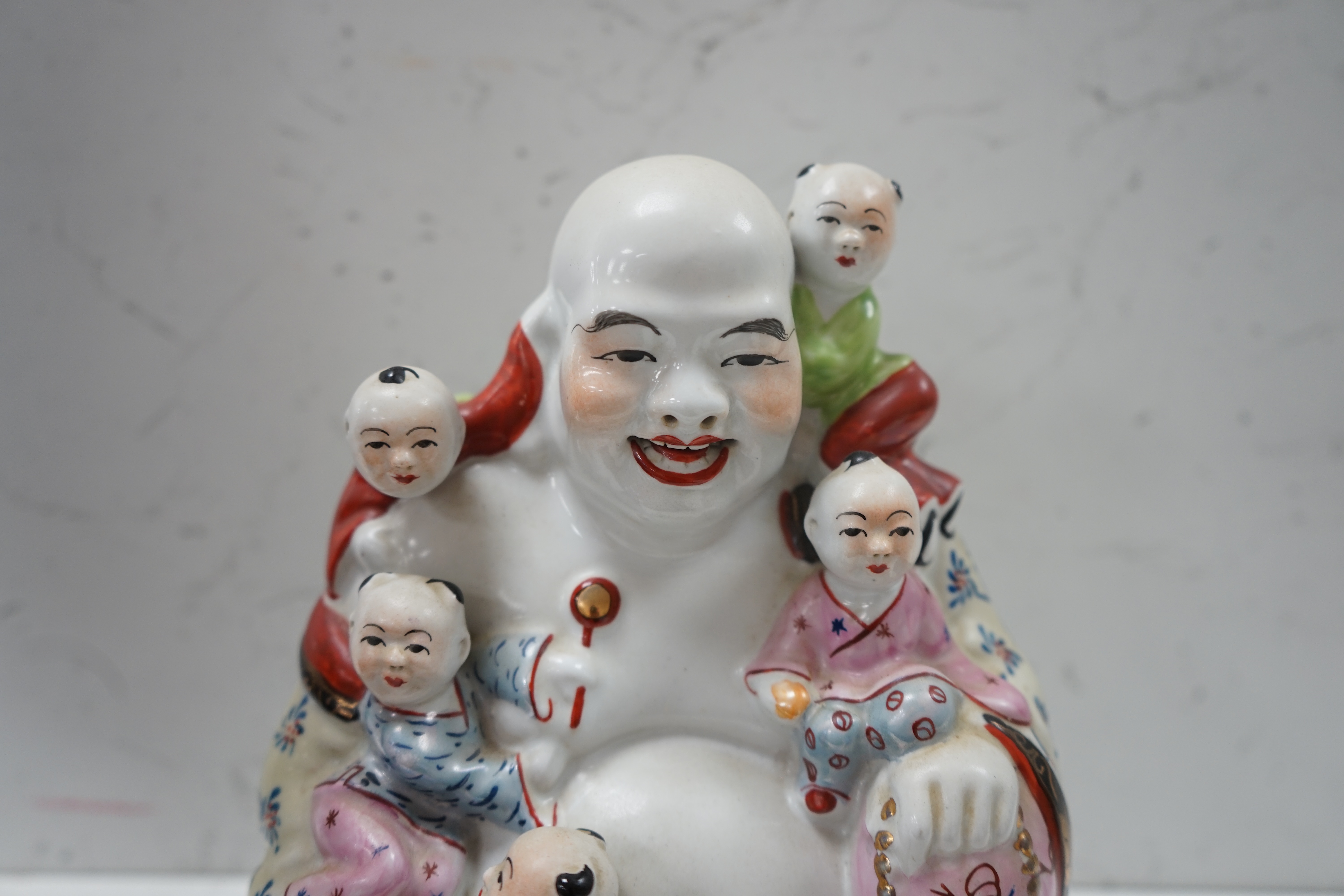 A Chinese enamelled porcelain Budai group, 20cm. Condition - good